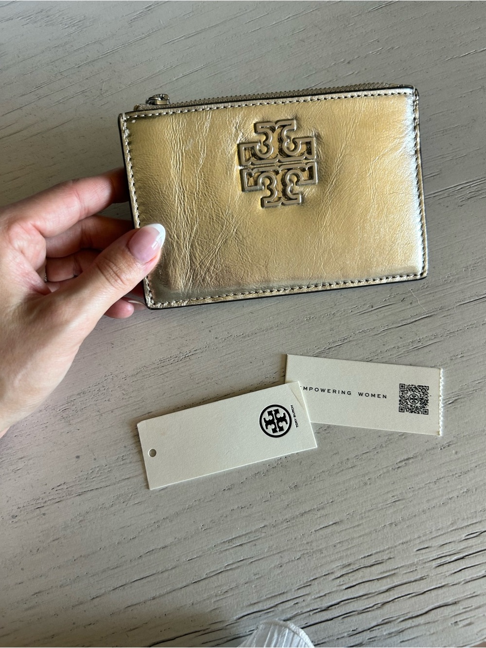 Tory Burch Shiny Gold Zip Card Wallet with silver zipper.